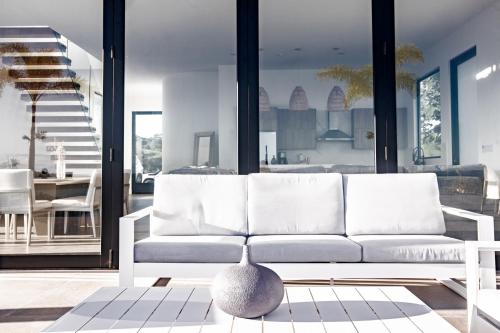 a living room with a white couch and a table at Ocean view luxury Villa, Private Pool 4BD 8PPL in Playa Venao