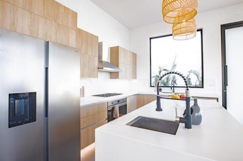 a white kitchen with a sink and a window at Ocean view luxury Villa, Private Pool 4BD 8PPL in Playa Venao