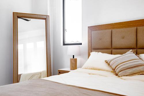 a bedroom with a large white bed with a mirror at Ocean view luxury Villa, Private Pool 4BD 8PPL in Playa Venao