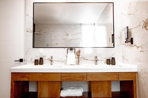 a bathroom with a sink and a mirror at Ocean view luxury Villa, Private Pool 4BD 8PPL in Playa Venao