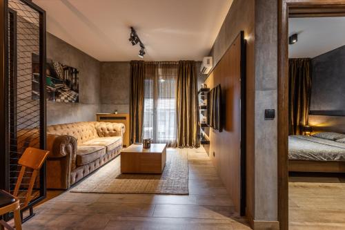 a living room with a couch and a bed at Bella Roe Premium Apartments in Belgrade
