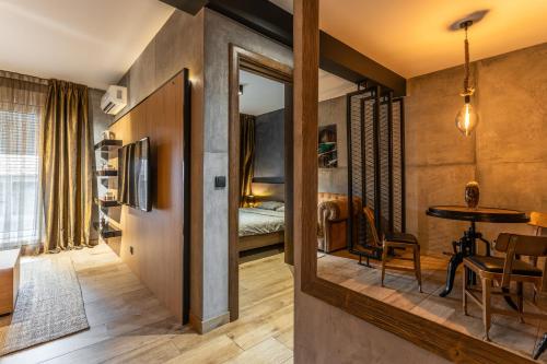 a room with a mirror and a table and a bed at Bella Roe Premium Apartments in Belgrade