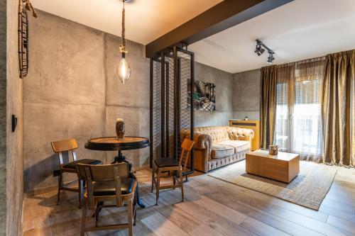 a living room with a table and chairs and a couch at Bella Roe Premium Apartments in Belgrade