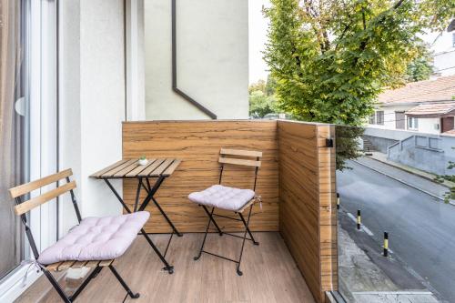 a small balcony with a table and two chairs at Bella Roe Premium Apartments in Belgrade