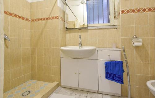 a bathroom with a sink and a mirror at 1 Bedroom Pet Friendly Apartment In Acireale in Acireale