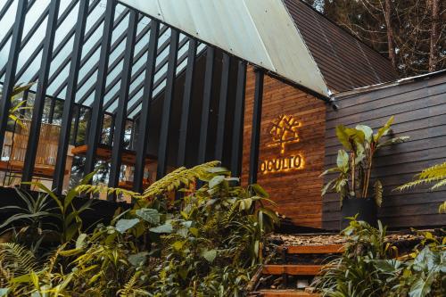 a building with a sign on the side of it at Oculto refugio de bosque in Envigado