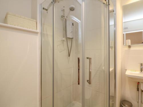 a shower with a glass door in a bathroom at The Mew in Dartmouth