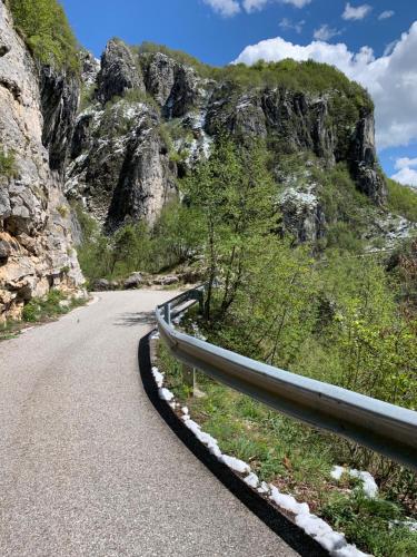 a winding road on a mountain with rocks and trees at VILLA MARGHERITA in Pieve di Soligo