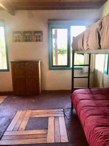 a bedroom with a bunk bed and a wooden floor at Hostel Raíz in Pucón