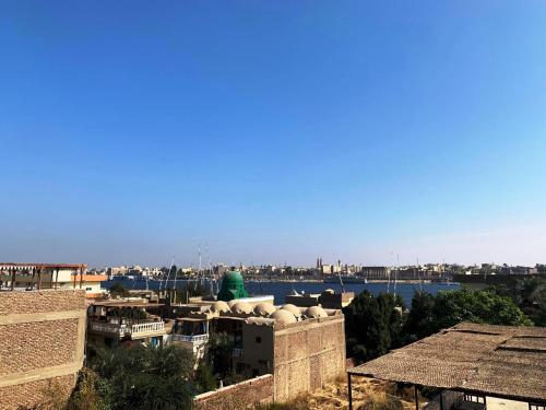 a view of a city with a body of water at Temple House Luxor in Luxor