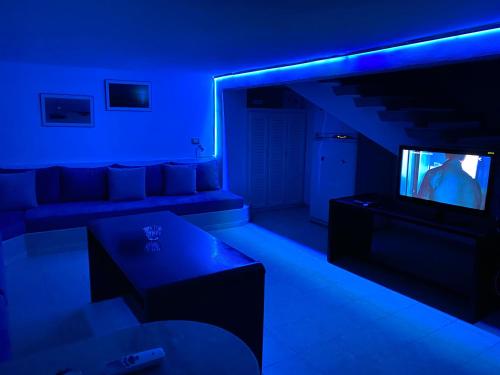 a living room with a couch and a tv at Elegant Relaxing Oasis in the Heart of Sfax in Sfax