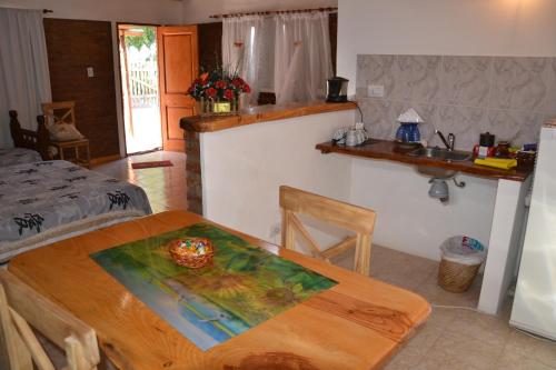 a kitchen with a table and a sink in a room at Cabañas Comarca del Colorado in Río Colorado