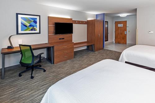 a hotel room with two beds and a desk with a computer at Holiday Inn Express Hotel & Suites Lafayette South, an IHG Hotel in Lafayette
