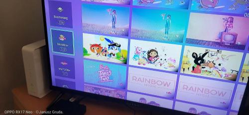 a television screen with a bunch of cartoons on it at Mieszkanie dwupokojowe 33m in Siedlce
