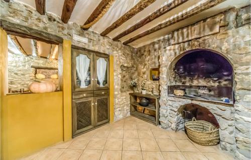 a stone room with a stone fireplace in a house at Stunning Home In Les Coves De Vinromá in Les Coves de Vinroma