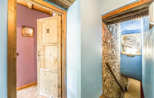 a wooden door in a room with a stone wall at Stunning Home In Les Coves De Vinromá in Les Coves de Vinroma