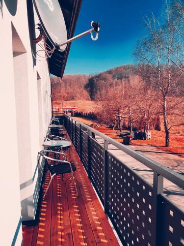 a balcony with a row of benches on a fence at Apartments & rooms Saša in Podčetrtek