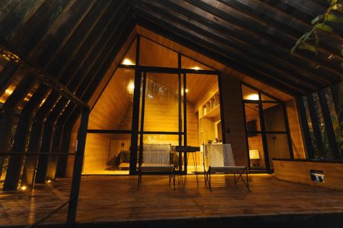 a room with a large window and a table and chairs at Oculto refugio de bosque in Envigado
