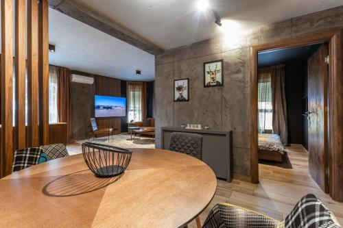 a room with a table and chairs and a bedroom at Bella Roe Premium Apartments in Belgrade
