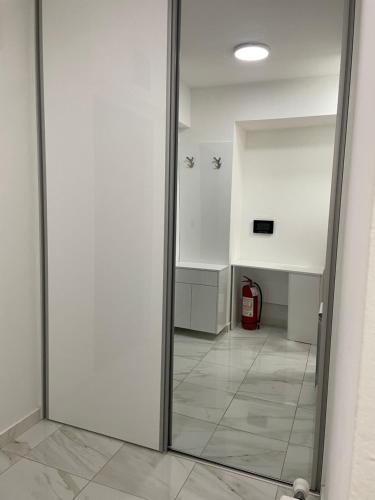 a glass door in a hallway with a fire hydrant at Luka Apartments Flatiron in Skopje