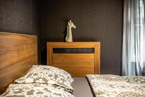 a bedroom with a bed and a giraffe statue on the wall at Bella Roe Premium Apartments in Belgrade