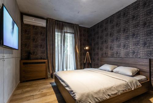 a bedroom with a bed and a flat screen tv at Bella Roe Premium Apartments in Belgrade