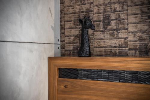 a statue of a giraffe sitting on top of a dresser at Bella Roe Premium Apartments in Belgrade
