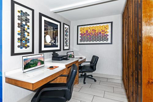 an office with a desk with a computer and two chairs at Holiday Inn Express & Suites Lafayette South by IHG in Lafayette