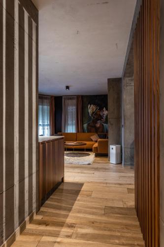 a hallway with a living room with a couch at Bella Roe Premium Apartments in Belgrade