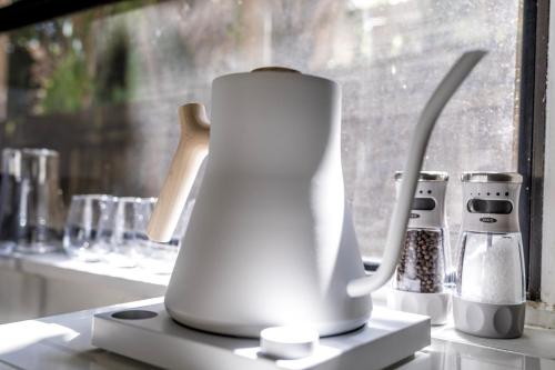 a white blender sitting on a counter next to a window at The Grandview Collection - FL Ave in West Palm Beach