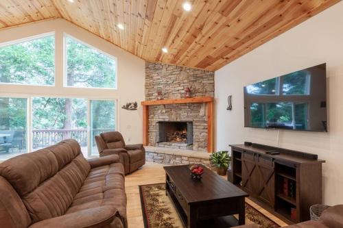 a living room with a couch and a fireplace at Hillside Hideaway - game rm - master spa - Luxury in Lake Arrowhead
