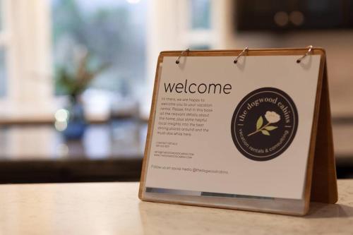 a welcome sign sitting on top of a table at Hillside Hideaway - game rm - master spa - Luxury in Lake Arrowhead