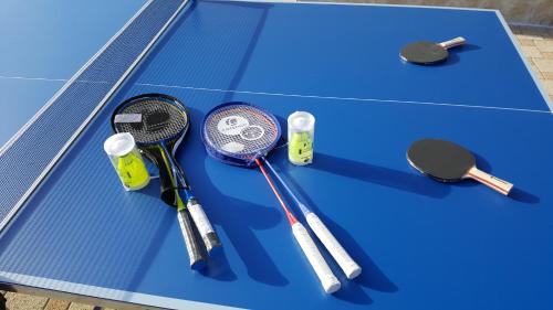a group of tennis rackets on a blue table at Luxury Villa Sun Stone heated pool & whirlpool in Trogir