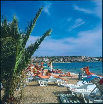 a group of people laying on the beach at Luxury Villa Sun Stone heated pool & whirlpool in Trogir