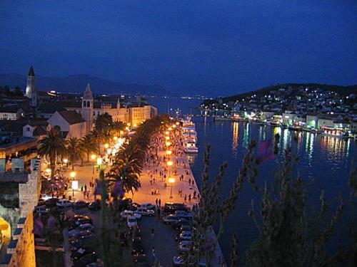 a city at night with boats in a harbor at Luxury Villa Sun Stone heated pool & whirlpool in Trogir