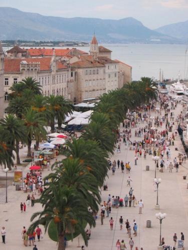 a large group of people walking down a city street at Luxury Villa Sun Stone heated pool & whirlpool in Trogir