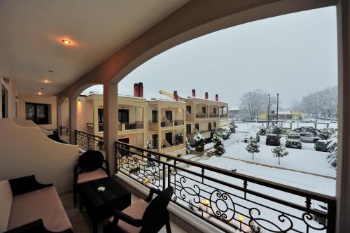 a balcony with a view of a snow covered street at Eliton Hotel & Spa in Kato Loutraki