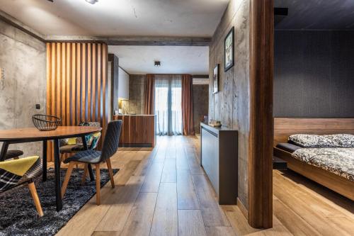 a bedroom with a bed and a table and chairs at Bella Roe Premium Apartments in Belgrade