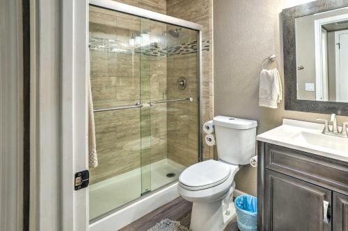 a bathroom with a shower and a toilet and a sink at Peoria Oasis with Resort Amenities, 2 Mi to Downtown in Peoria