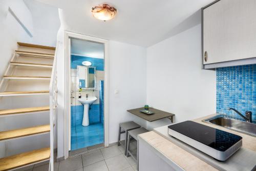 a small kitchen with a sink and a counter top at Honeymoon Beach Studios in Perivolos