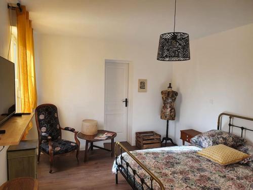 sypialnia z łóżkiem, stołem i krzesłem w obiekcie Pavillon d'Aÿ cottage Champagne - Label Green Key w mieście Ay