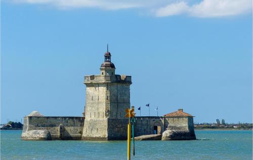 a lighthouse on a island in the water at 4 Bedroom Stunning Home In Fouras in Fouras