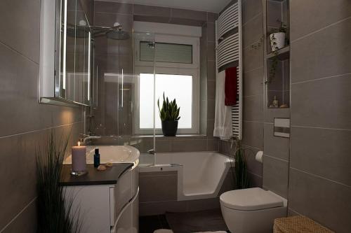 ein Badezimmer mit Badewanne, Toilette und Waschbecken in der Unterkunft MD-7 Lutherstrasse 15 - Luxus-Wasserbett-SmartTV-Terrasse-2Schlafzimmer in Magdeburg