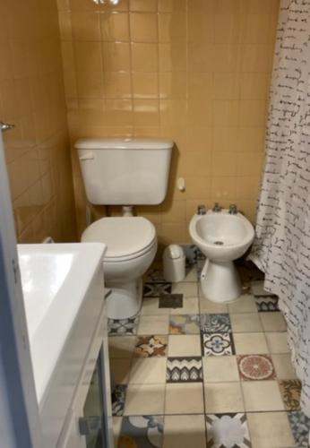 a bathroom with a toilet and a sink at Studios Montevideo in Buenos Aires