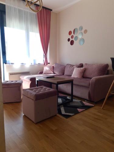 a living room with a couch and a table at Apartman M2 Titova Vila in Palisat