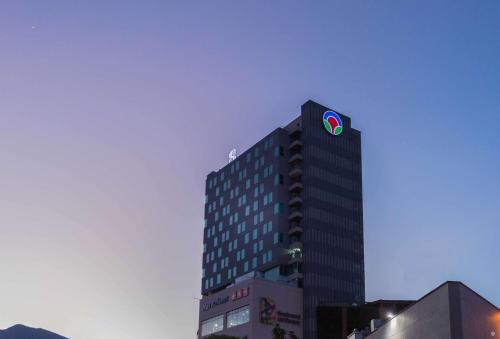 a building with a sign on the top of it at Sonesta Hotel Bucaramanga in Bucaramanga