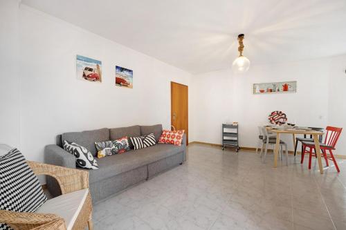 a living room with a couch and a table at Casa Farol in Portimão