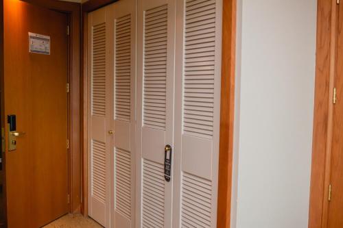 a closet with white doors in a room at Sonesta Hotel Osorno in Osorno