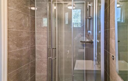 a shower with a glass door with a person taking a picture at Stunning Home In Bjelland With 3 Bedrooms in Bjelland