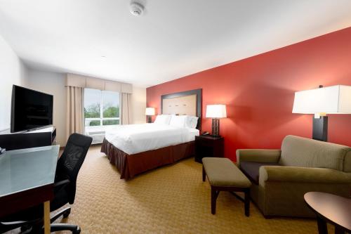 a large hotel room with a bed and a television at Holiday Inn Temple - Belton, an IHG Hotel in Temple